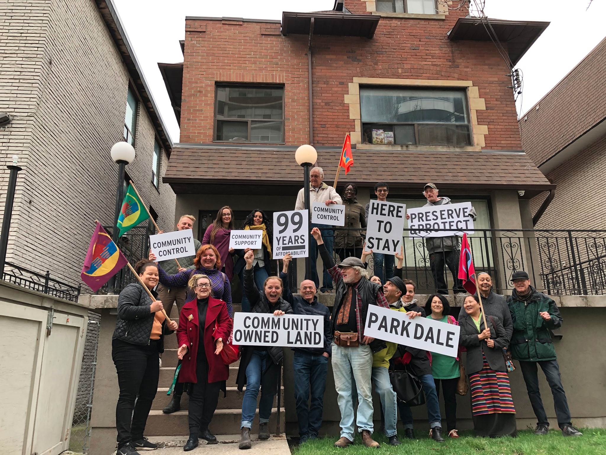 PNLT members and supporters celebrate the purchase of a 15-unit rooming house in Parkdale, the first affordable housing project of the land trust.